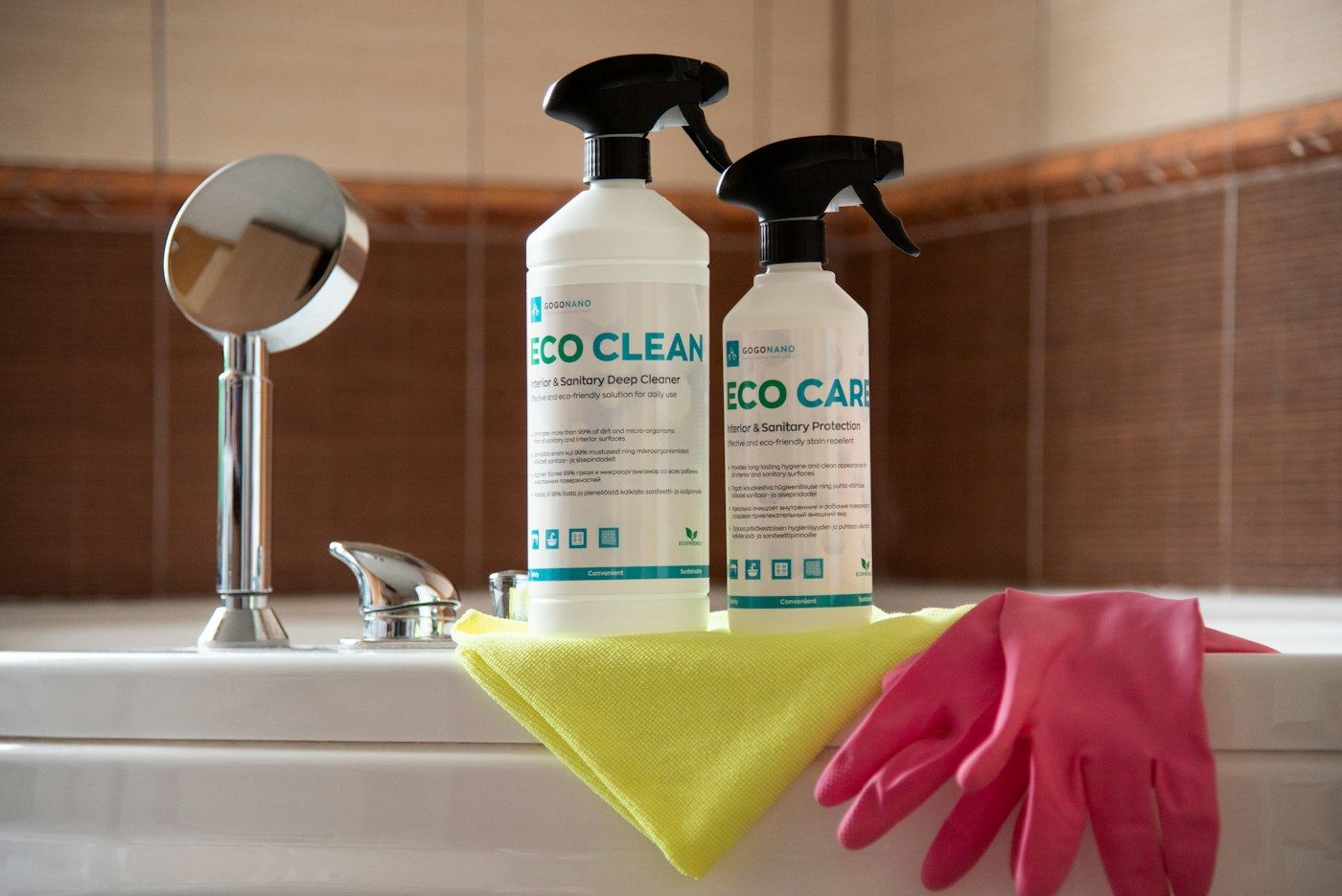 Cleaning supplies and gloves on a bathtub edge