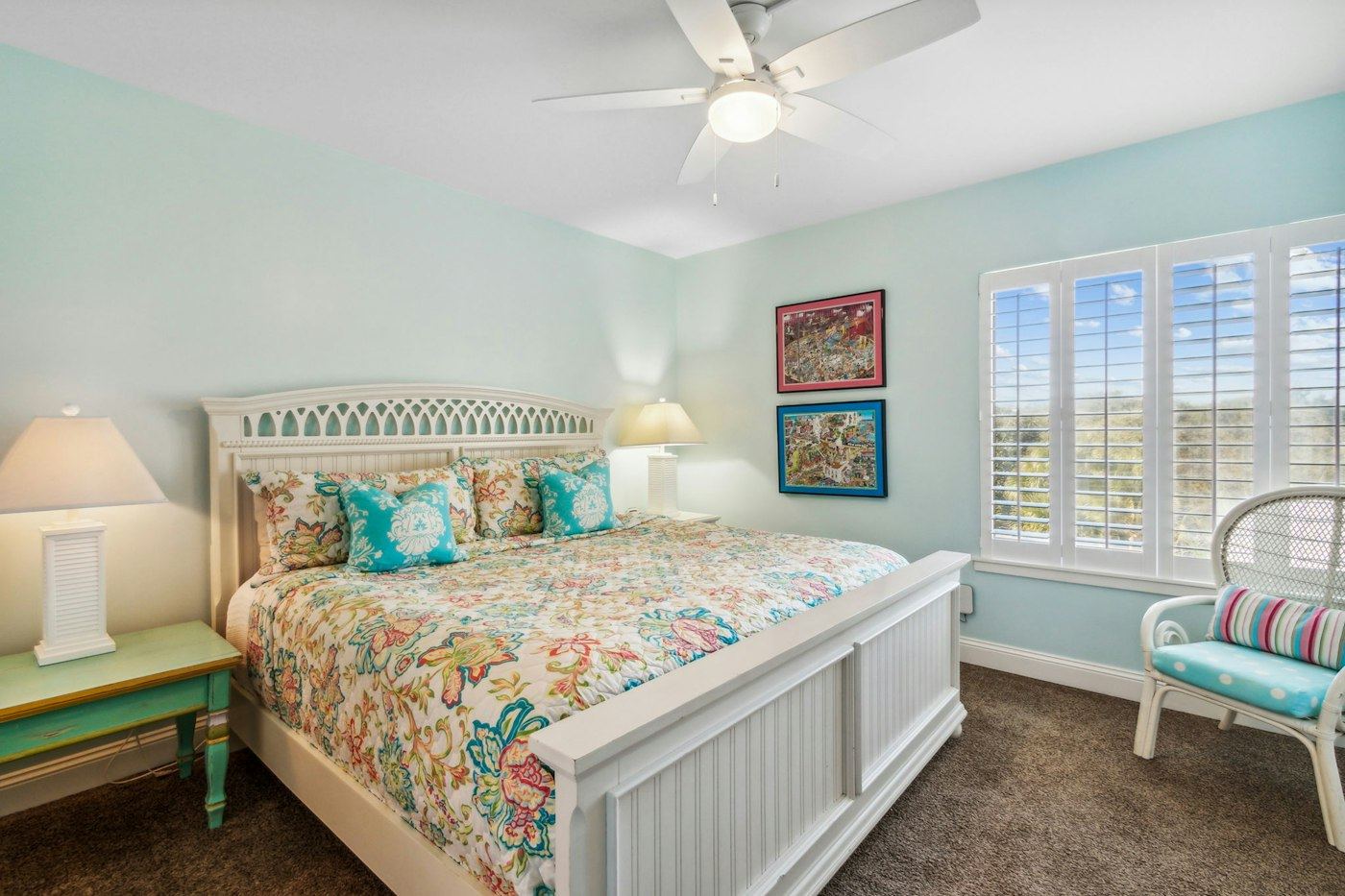Bright coastal bedroom with a made bed